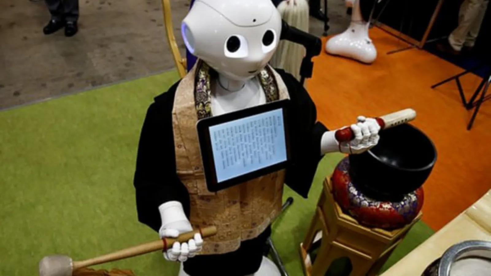 Photograph of Pepper, humanoid robot wearing religious clothing.