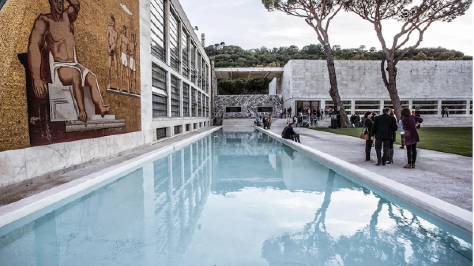 An outdoor swimming pool adjacent to a building