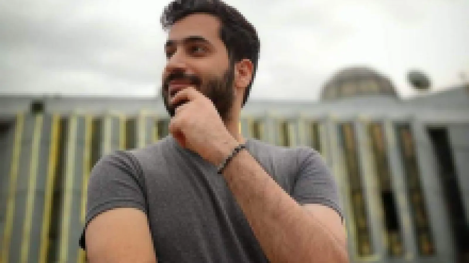 A Palestinian Man smiling and wearing a tshirt