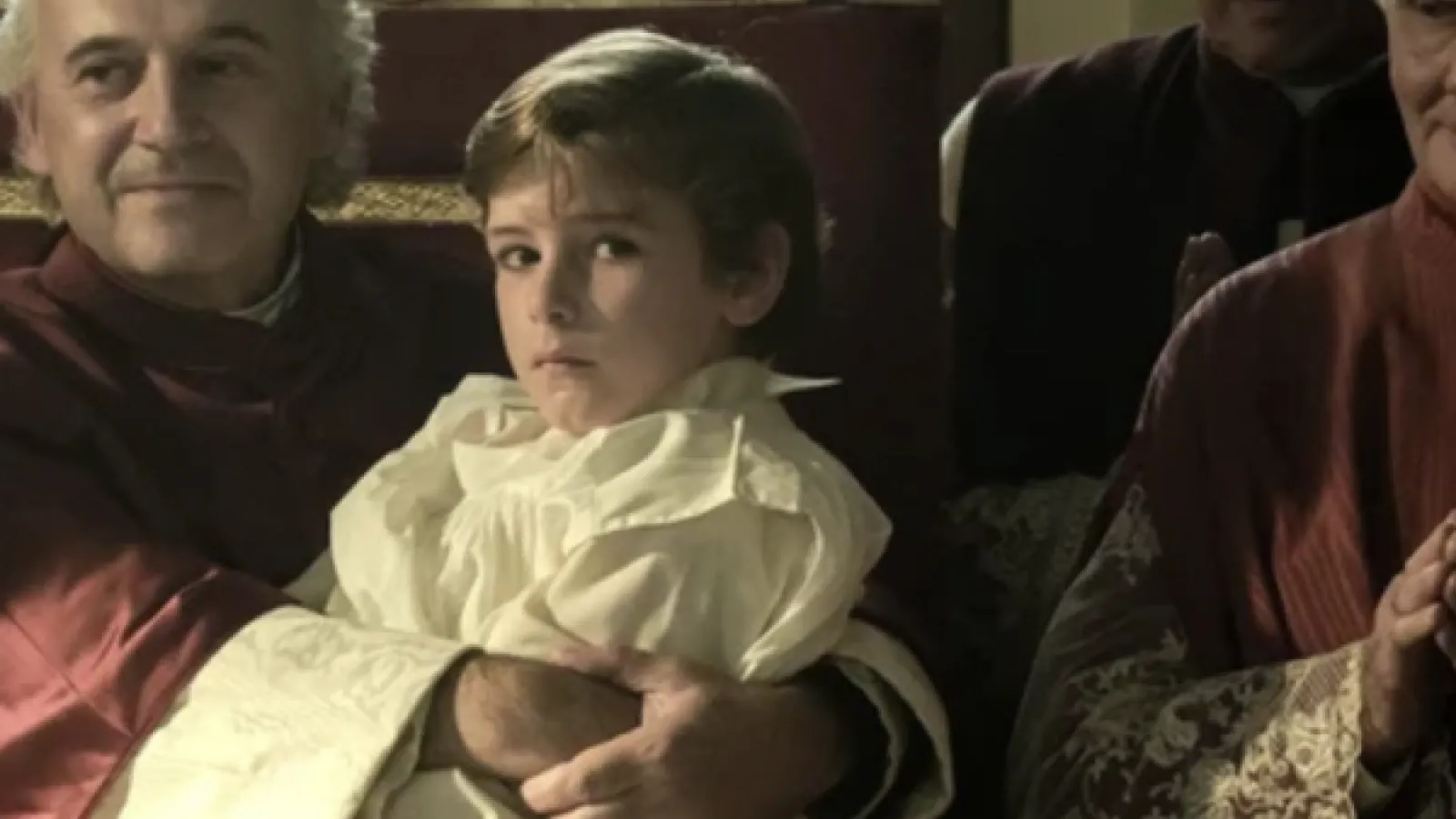 Young boy sitting on the Pope's lap 