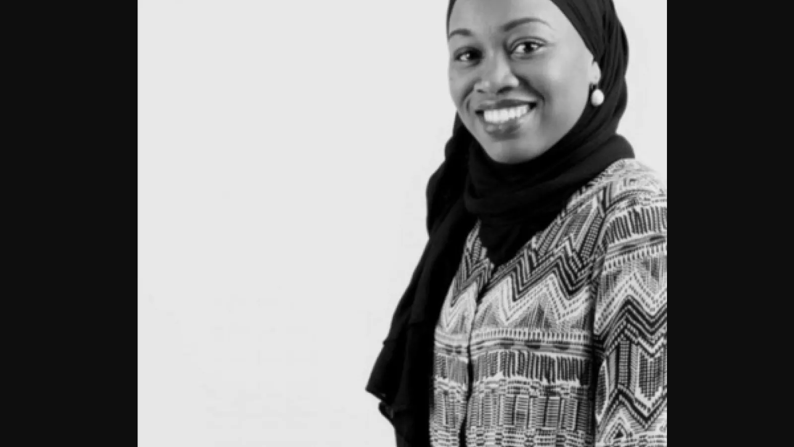 Woman in hijab smiling at camera