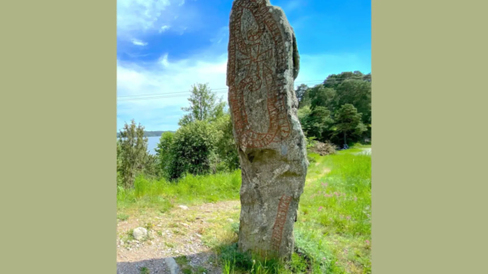 A tall rock standing in a field