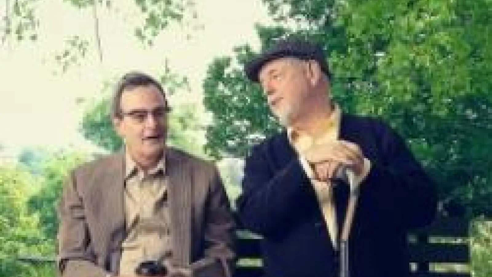 two men sitting on a bench