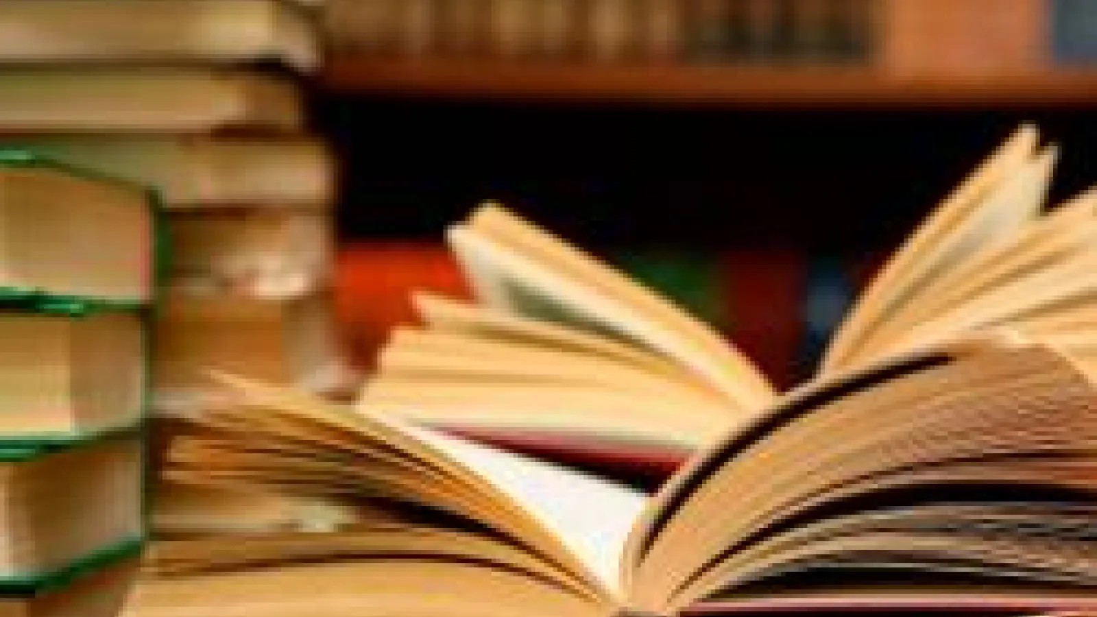 Two stacks of books and two books that are open facing up
