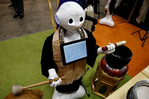 Photograph of Pepper, humanoid robot wearing religious clothing.