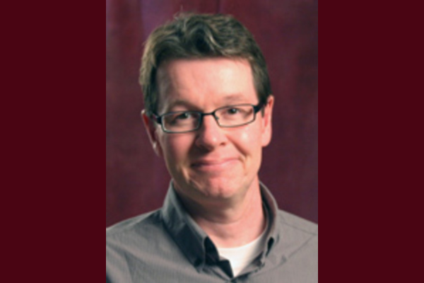 Headshot of Chris Highley, a white man with small glasses and short brown hair