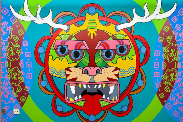 An artistic image of a four-eyed mammal with antlers and fangs