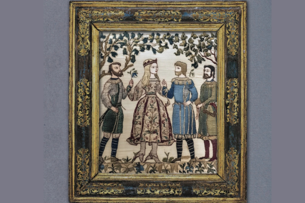 An embroidered scene with a young woman in the middle and two men on either side. They are wearing medieval clothing. 