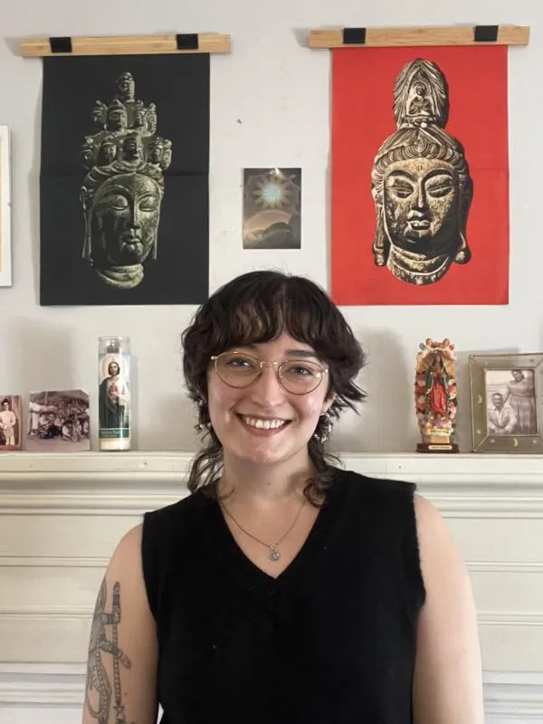 Sierra Bernal standing in front of candles and pictures on a mantel