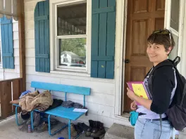 Anisa Kline in front of a door
