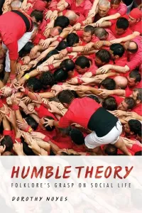 Cover: Photo of a bunch of men in red shirts gathered together with their hand outstretched to the center left